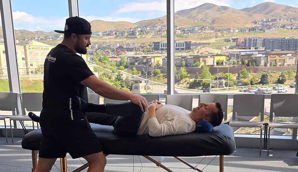 OnSite practitioner assisting a stretch in a bright Utah studio